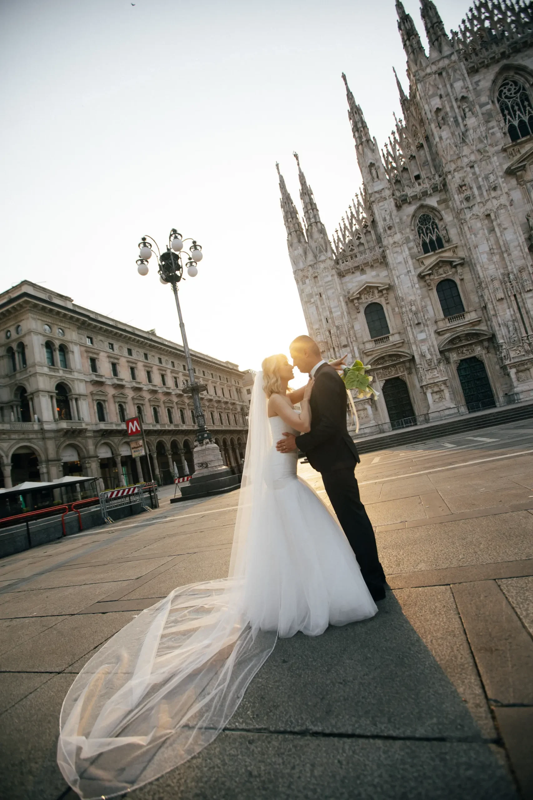 Elegant wedding couple walking through historic streets of Milan – fashion-style photo