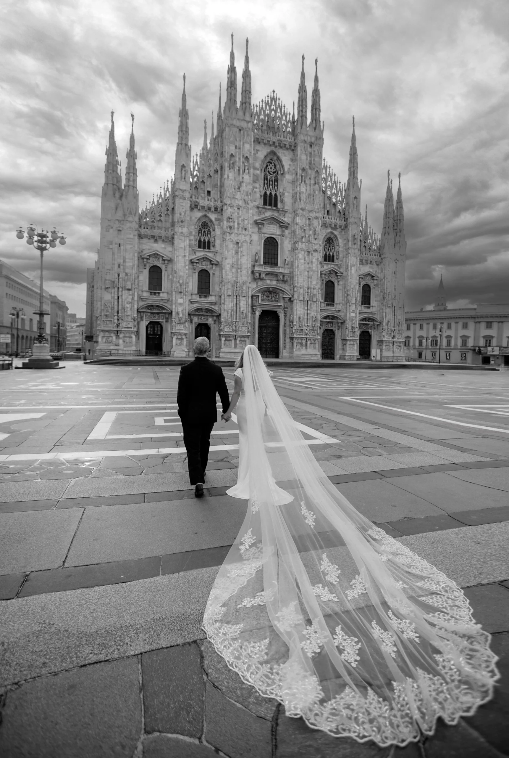 legant wedding couple walking through historic streets of Milan – fashion-style photo