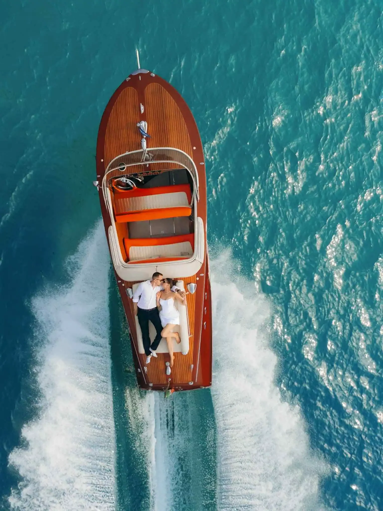 Bride and groom on a boat at sunset on Lake Como – cinematic wedding photo