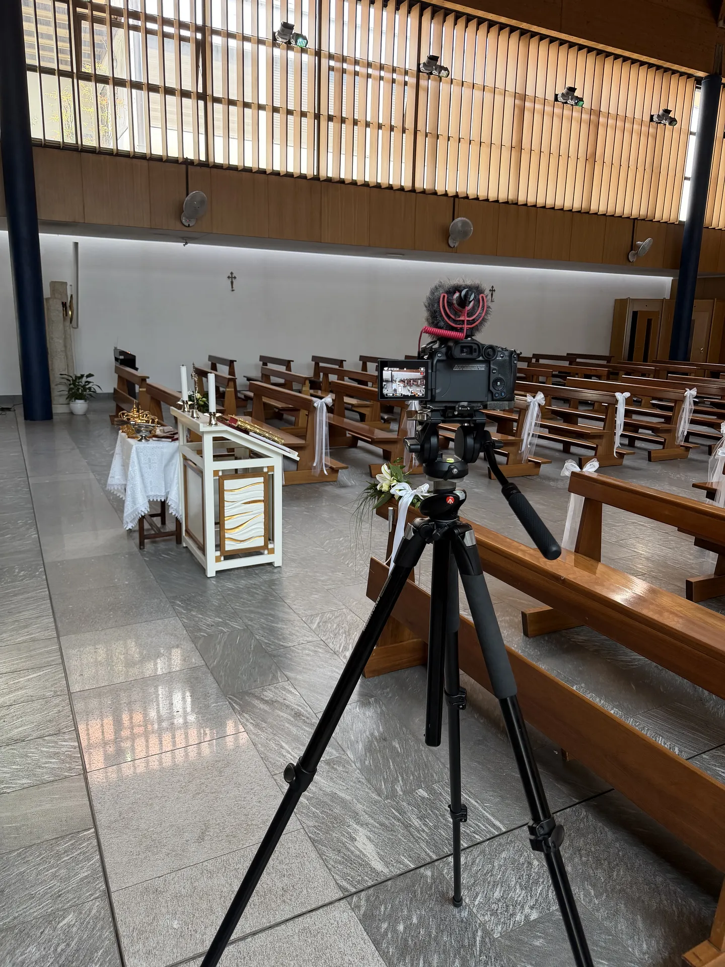 Professional wedding video camera recording a church ceremony in Italy