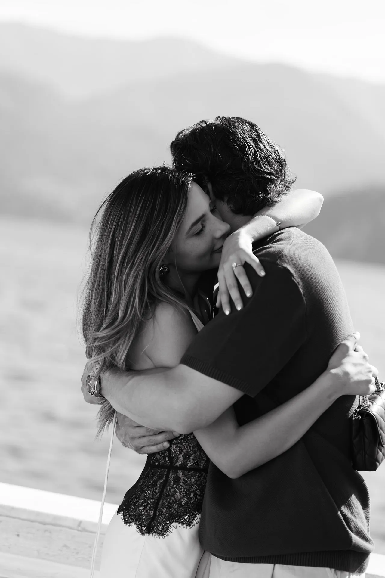 Black and white engagement embrace on Lake Como