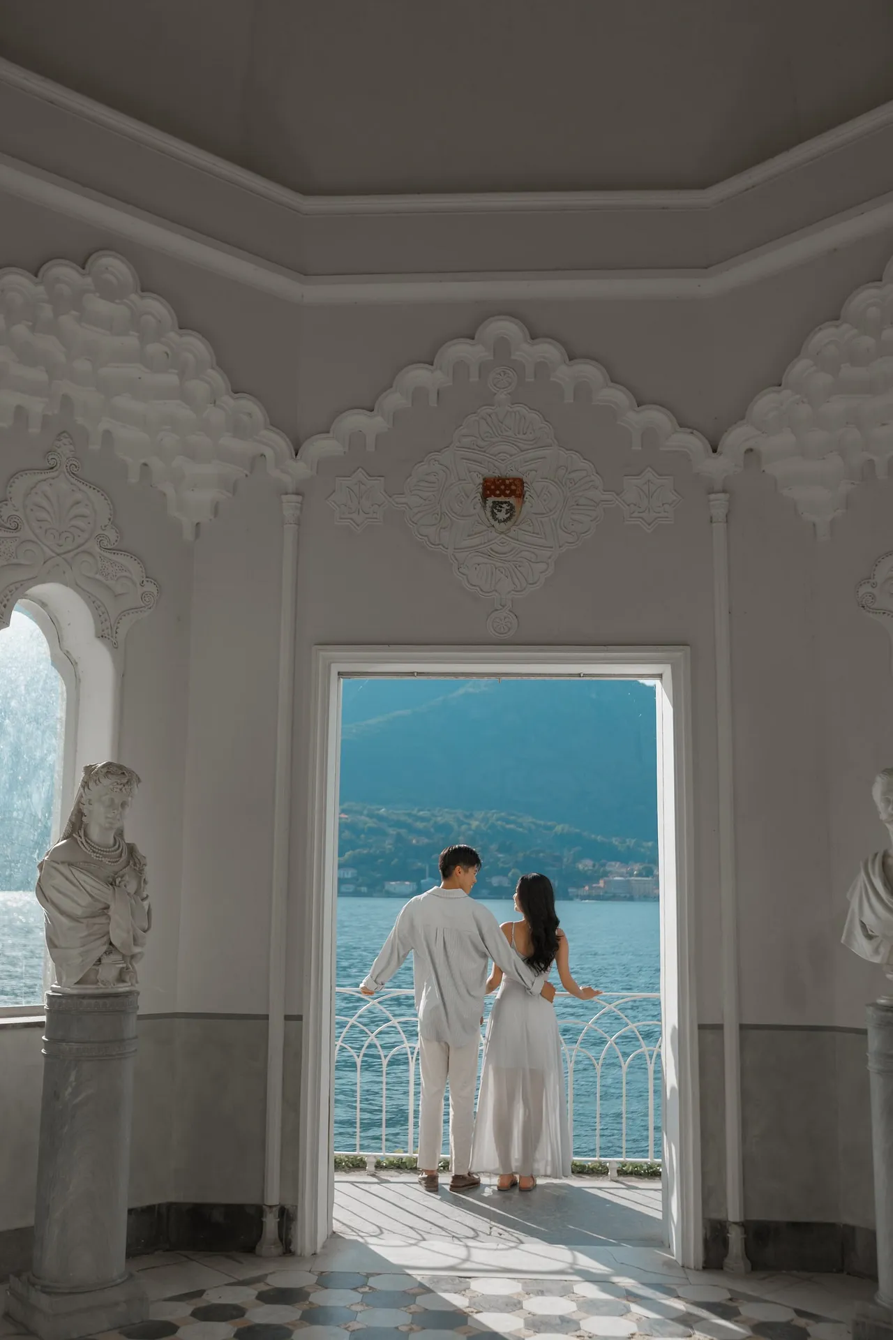 Romantic engagement session near a doorway at Villa Melzi on Lake Como